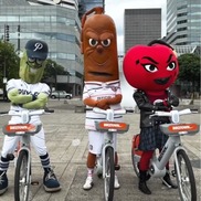 Three costumed mascots for local sports teams pose on BIKETOWN e-bikes for Guinness World Records attempt