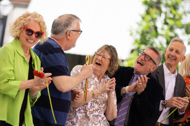 Darcelle's son and daughter (center) cut the ribbon at the plaza's soft opening alongside Councilors Smith and Ryan and Mayor Wilson.