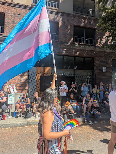 Councilor Koyama Lane at Portland Pride Parade waiving a Trans Pride Flag