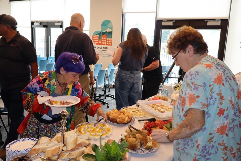 Pictured: Neighbors connecting over coffee and conversation before the community discussion began.