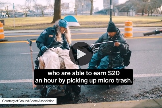 Screenshot of a video featuring workers in wheelchairs picking up litter on a Portland roadway.