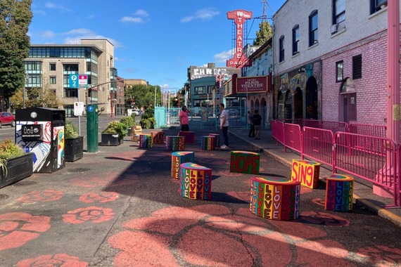 Ankeny Alley in downtown Portland has roses painted in the straight, no traffic, and wooden seats with rainbows.