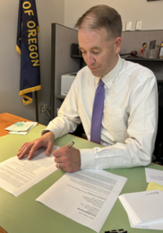 Secretary Read signing letters at his desk