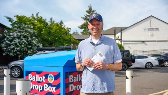 Secretary Read returning his ballot at an official ballot drop box. 