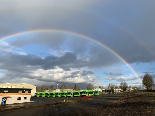 Double rainbow over articulated TriMet FX buses