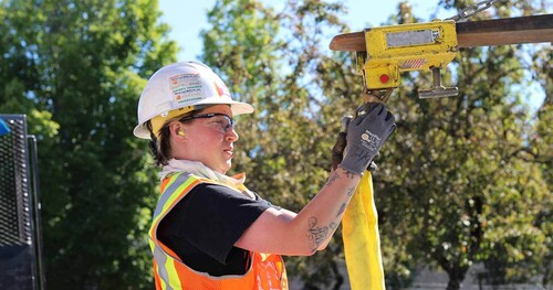 A construction worker is building a TriMet project.