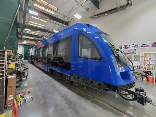 MAX train 418 painted with blue and orange colors