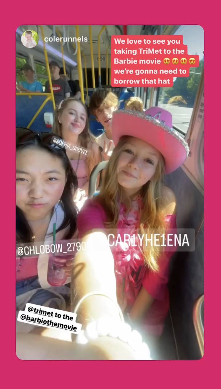 Riders in pink-colored outfits taking the bus to the Barbie premiere