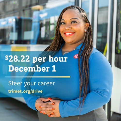 TriMet employee standing next to a bus