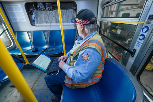 Mechanic performing work on board a bus