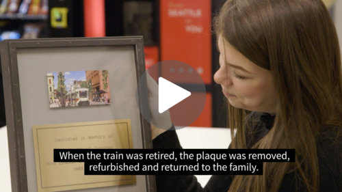 Woman holding up a plaque