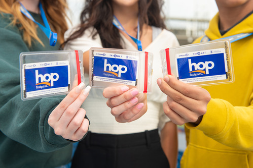 3 students holding up their summer passes