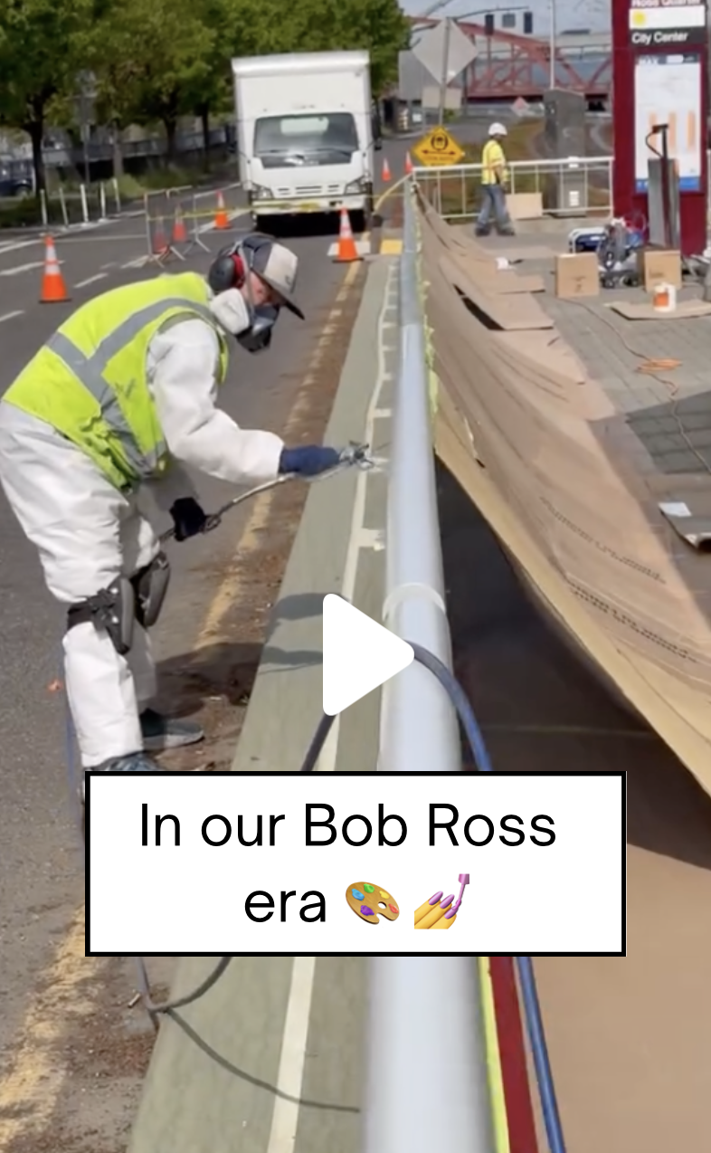 TriMet employee using paint sprayer at a station
