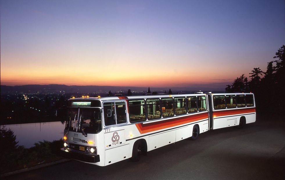 Vintage articulated bus with red, orange and brown stripes on the side