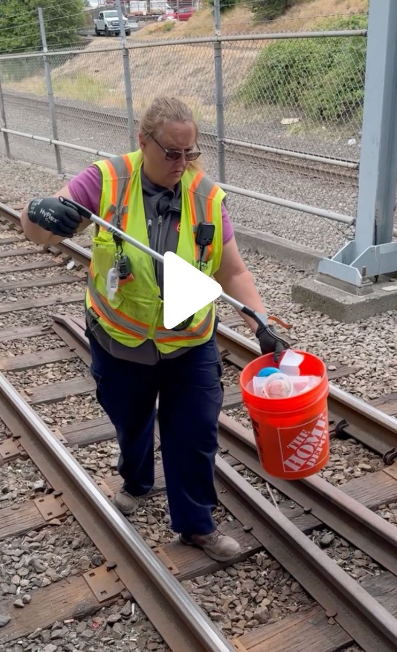 Cleaner on the MAX tracks picking up litter