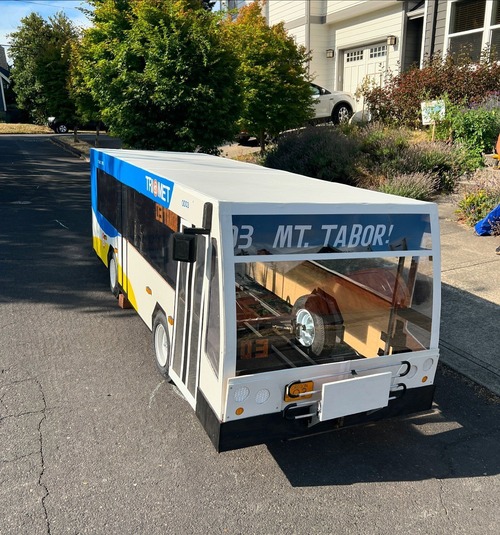 Soap box bus with a "Mt. Tabor" sign sitting in front of a house