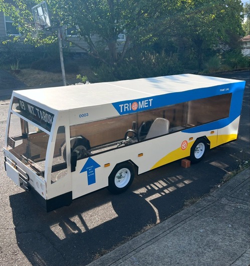 Soap box bus with a "Mt. Tabor" sign sitting in front of a house