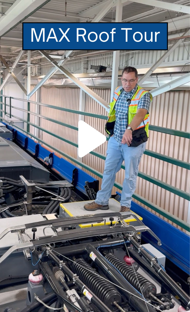 Man on top of the roof of a MAX train