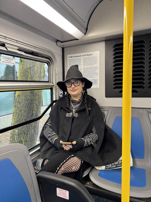 rider dressed as a witch on a bus 