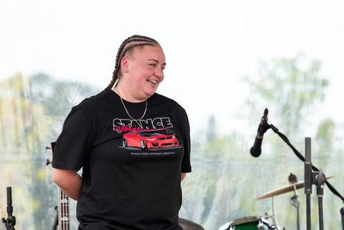 Rail operator of the year Shana Peck on stage, wearing a black tshirt. Her long hair is braided in cornrows