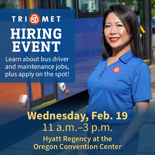TriMet bus driver smiling in front of a bus