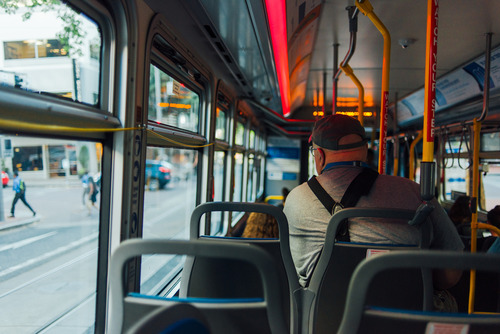 Image of the interior of a TriMet bus with several riders on board in Downtown Portland