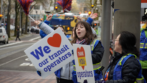 Image of TriMet employees with "We (heart) our transit operators" and "Thank you operators" signs in Downtown Portland