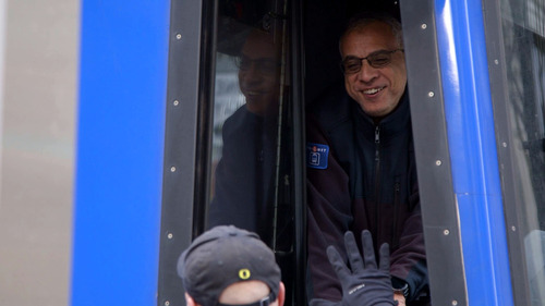 Image of a MAX operator and another TriMet employee exchanging pleasantries in Downtown Portland