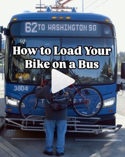 man loading a bike on an electric bus