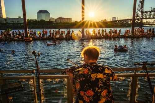 Musician plays violin at sunset on Portland’s Duckworth Dock