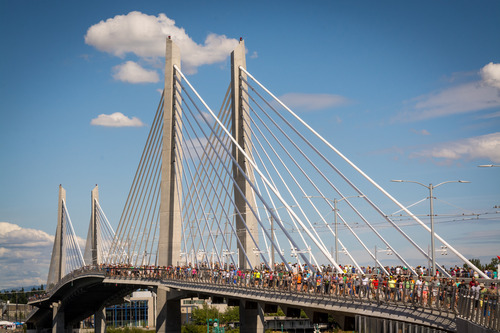 Image of Tilikum Crossing in Portland, crowded with people crossing the bridge on a sunny summer day