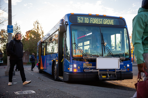 Riders walking away from blue TriMet Line 57 bus