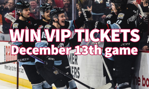 A group of hockey players celebrating on the ice in front of an excited crowd