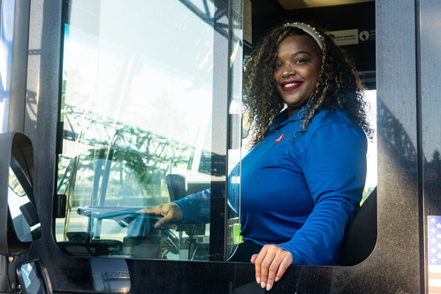 TriMet 2025 Bus Operator of the Year Leslie Newton sits in the driver's seat of her bus.