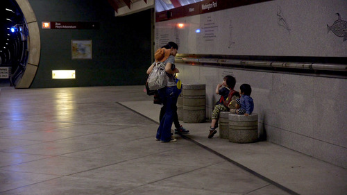 A family checking out educational displays at the Washington Park MAX Station in Portland.