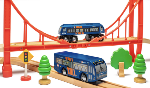 A colorful toy scene featuring miniature TriMet vehicles on wooden tracks