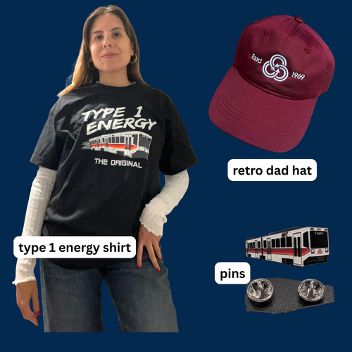 Person in a black “Type 1 Energy” train T-shirt with images of a burgundy TriMet vintage logo hat and a train pin