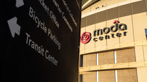 A sign in front of Moda Center points to TriMet's Rose Quarter Transit Center