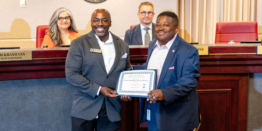 Councilmember James Alberson, Jr. posing with his Certificate of Municipal Leadership with Councilmember Ed Prince.