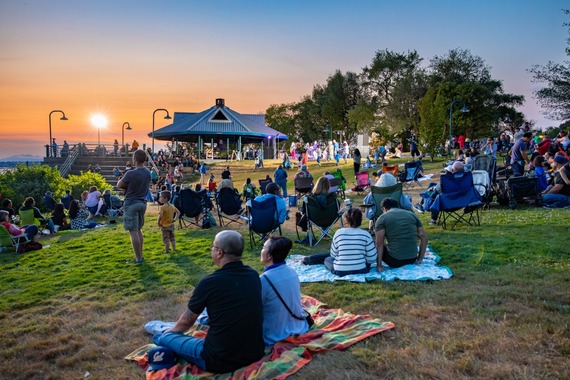 Friday evening at Renton River Days showcasing a sunset and concert in the background.