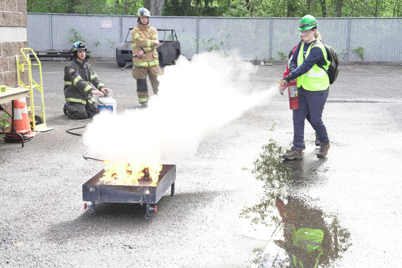 Community Emergency Response Team (CERT) putting out a fire in a CERT training