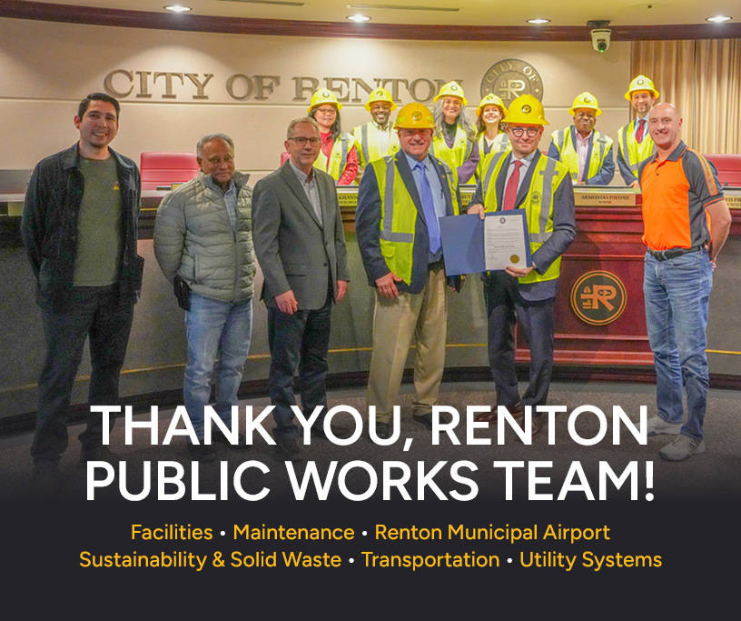 Proclamation group photo in council chambers showing Public Works employees, Renton City Council, and Mayor Armondo Pavone wearing work hard ha