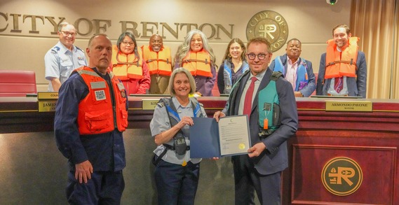 A proclamation group photo with a few individuals wearing life vests. Safe Boating & Paddling Week in Renton was proclaimed to be May 17-23