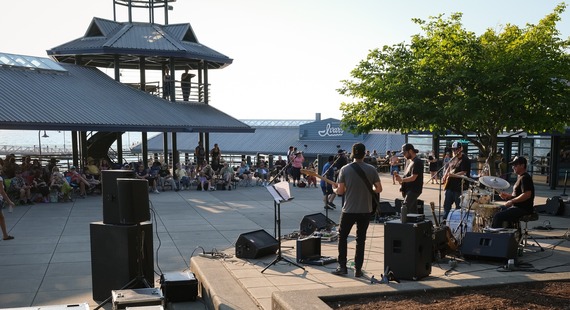 Summer Concert Series at Gene Coulon Memorial Beach Park. Musicians playing in front of a live crowd in the park