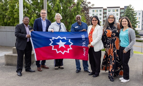 Mayor Armondo Pavone and Renton City Council posing next to the Juneteenth flag prior to raising it