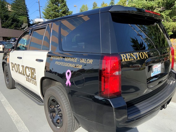 Renton Police Department vehicle with a purple ribbon to recognize Domestic Violence Awareness Month