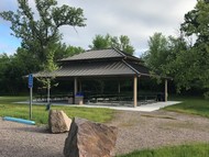 picnic shelter with tables and aggregate pathway