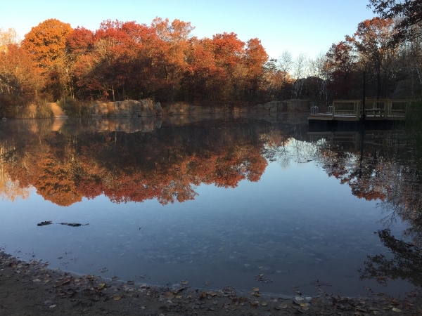 Quarry filled with water surrounded by fall colored trees