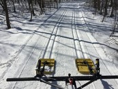 equipment setting up cross country ski trails through the snow