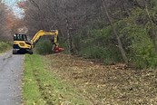 tree trimming equipment working along paved trail